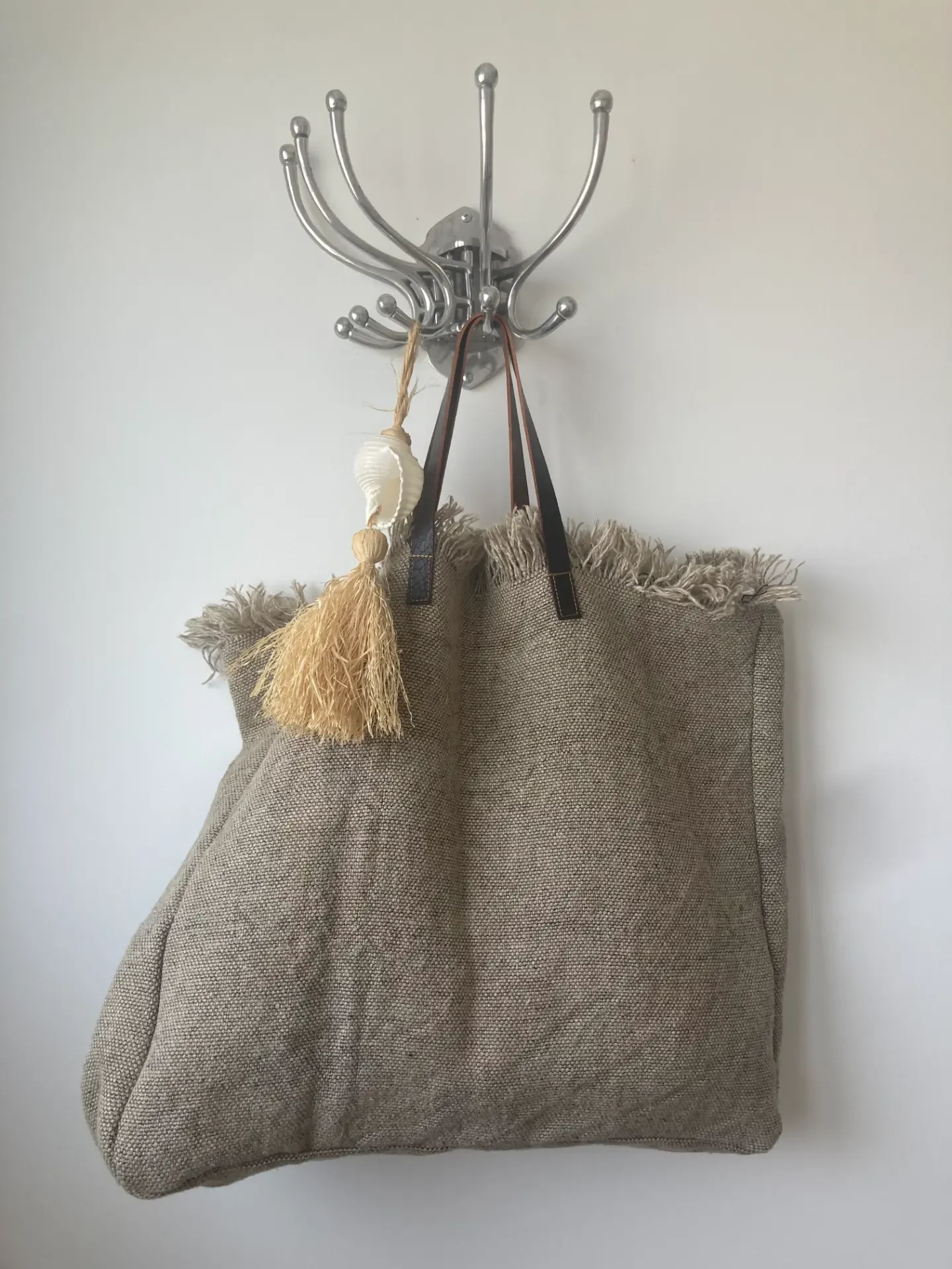 Beige men's sweater displayed on a neutral background