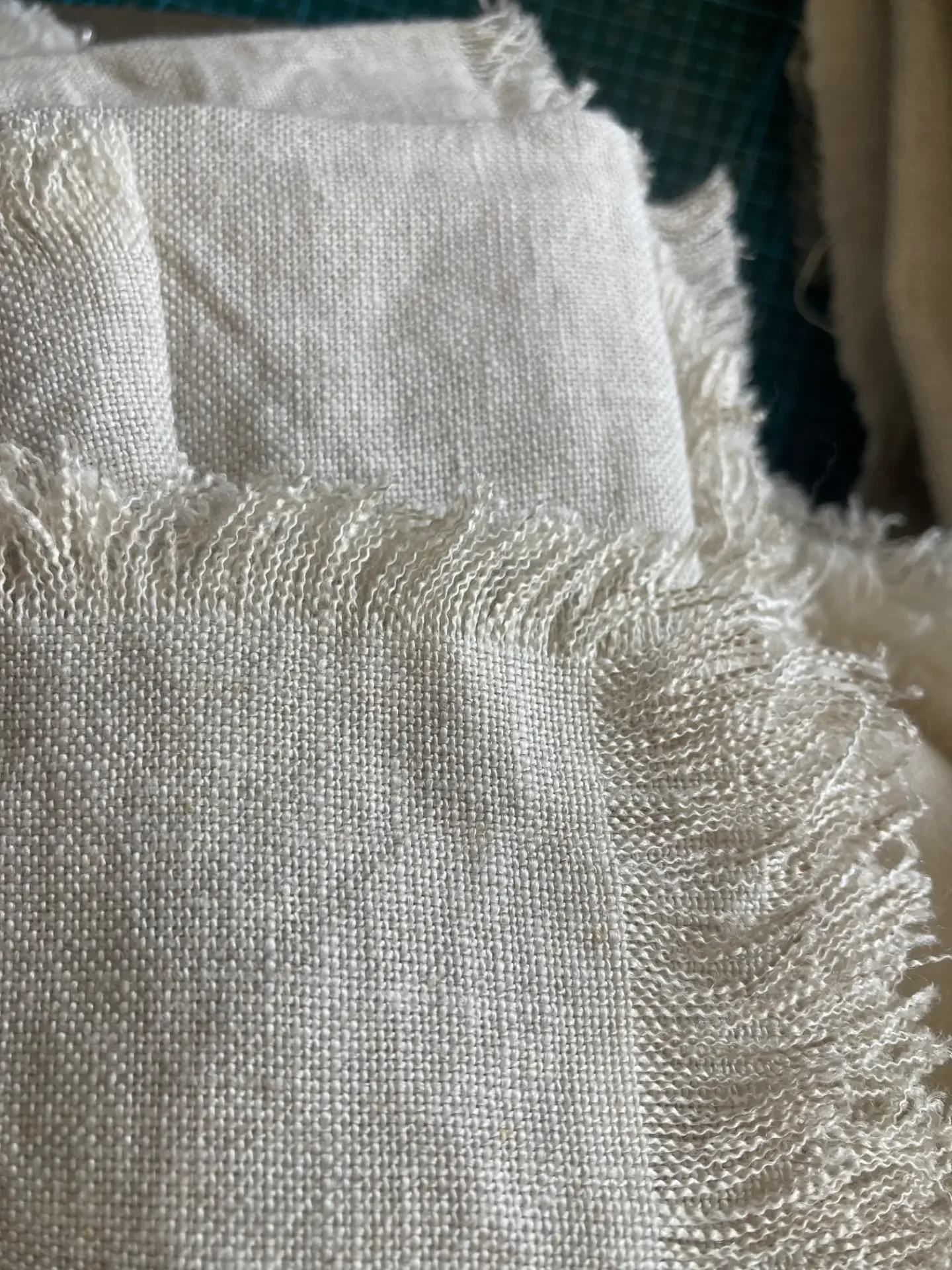 Off-shoulder knit dress displayed in a beige color